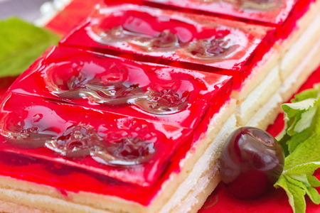 Summer dessert - sweet cold red jelly pie with cherriesの写真素材