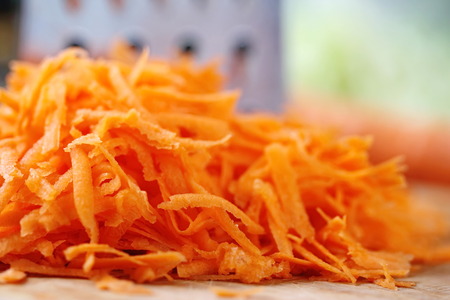 Fresh grated carrot prepared for cookの写真素材