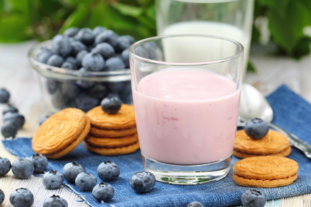 Blueberry yogurt in glass and fresh berriesの写真素材