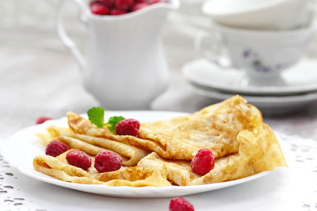 Breakfast homemade pancakes with raspberries and butterの写真素材