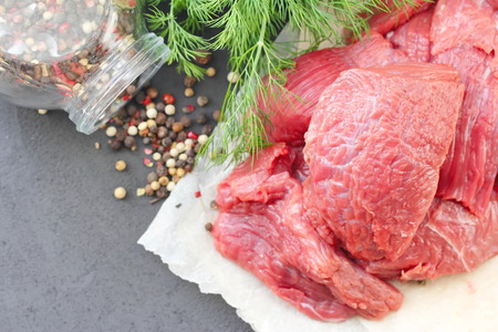 Raw beef with vegetables and spices ready for cookの写真素材