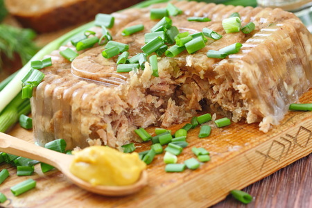 National cuisine. Russian traditional dish - Holodets. Homemade jellied meat with garlic and spices garnished with mustard and spring onion. The best food for Russian vodka.の写真素材