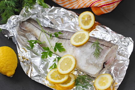 Raw fish with spices and lemon ready for baking