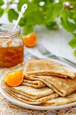 Pancakes with orange jam and fruit for breakfastの写真素材