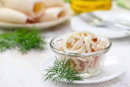 Seafood. Salad with boiled squids, greens and oilの写真素材