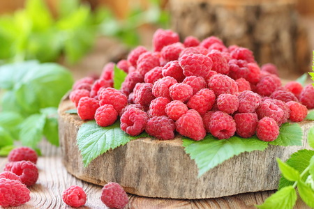 Fresh ripe raspberry on natural background in rustic style