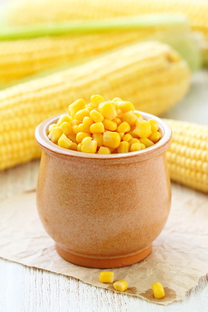 Seeds of canned sweetcorn in a bowlの写真素材
