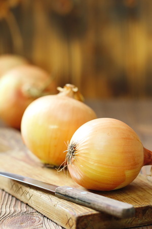 Heads of raw yellow onions ready for cookingの写真素材