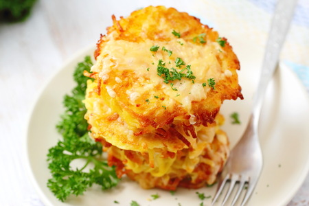 Fried potato pancakes with fresh parsley on a plateの写真素材