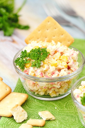 Traditional Russian salad with crab sticks and sweet cornの写真素材