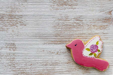 Wooden background with bird and Sun. Spring background with gingerbread for decorationの写真素材