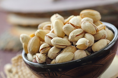 Pistachios nuts on wooden table. Vegan foodの写真素材