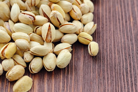 Pistachios nuts on wooden table. Vegan food