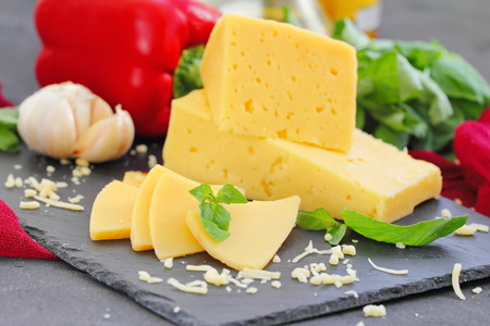 Cheese with basil and vegetables on the table