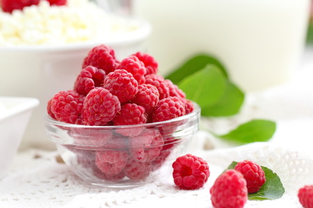 Fresh raspberry in a bowl and dairy product for healthy breakfast