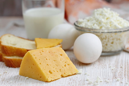 Dairy product for healthy breakfast. Cottage cheese, milk, eggs and cheese on the table. Healthy food.の写真素材
