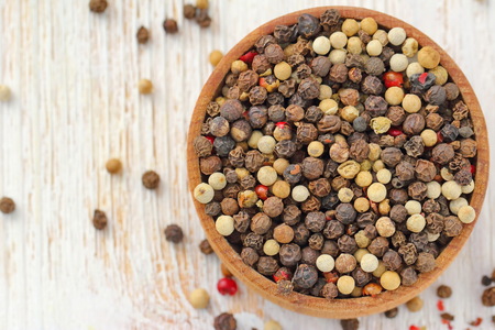 Peppercorn of different kinds in a bowlの写真素材