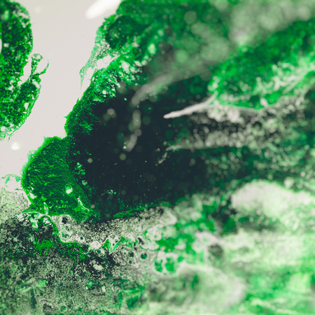 Liquid Acrylic paint, liquid artwork, abstract colorful background with colored painted cells, stains. Green retro colorsの写真素材
