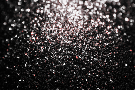 Black glitter sparkle background. Black friday shiny pattern with sequins. Christmas glamour luxury pattern, black christmas and glitter diamond background. Dark silver pattern.の写真素材
