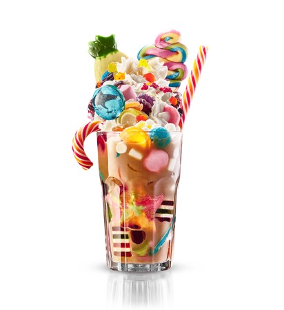 Colourful, festive cocktail with sweets, candy, jelly. Colorful array of different childs sweets and treats in cacao glass on white background. Sweet candies cociailの写真素材