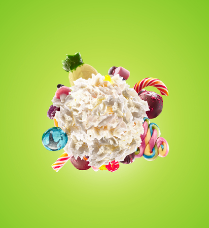 Whipped round cream with colored sweets, jelly and candies isolated. Sweet life concept. Sweet dessert - whipped milk cream concept with treat, kid cartoon colorful cream, white whipped cream with colored sweets. Monster freak milk shake whip creamの写真素材