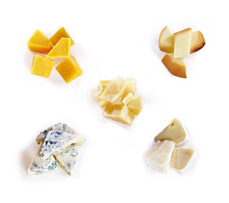 Different type of cheese with honey, grape, nuts on white background. Top view. Blue cheese, cheddar, parmesan, maasdam and brie cheese slicesの写真素材