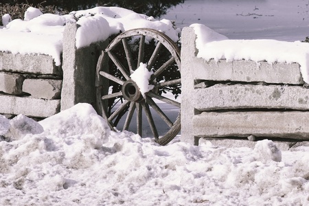 Wagon wheel in a stone wallの写真素材