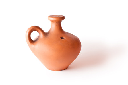Ancient clay jug of orange isolated on white の写真素材