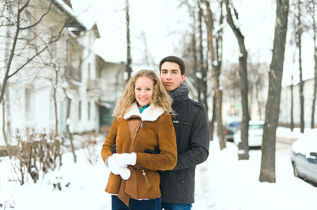 Outdoor happy couple in love posing in cold winter weatherの写真素材