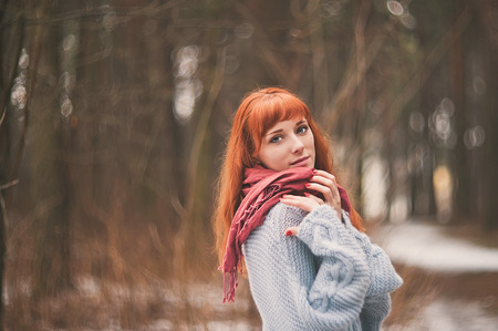 Hipster. Emotions. Photo lonely redheaded girl with a scarf.の写真素材