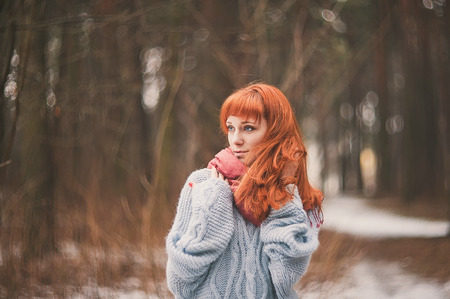Hipster. Emotions. Photo lonely redheaded girl with a scarf.の写真素材