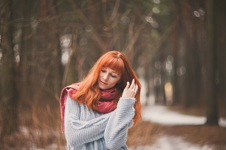 Hipster. Emotions. Photo lonely redheaded girl with a scarf.の写真素材