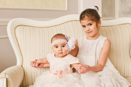 Portrait of two beautiful happy little sistersの写真素材