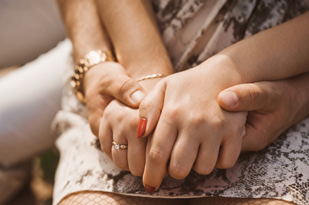 Hands of Young couple in loveの写真素材
