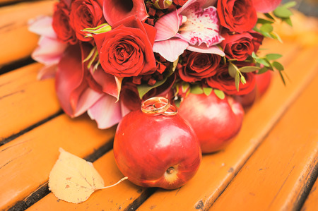 Gold rings and rowan berries in the autumn weddingの写真素材