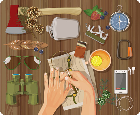 Workplace concept. Top view with textured table, feather, hands, phone, headphones, ax, flask, binoculars, matches, magnifying glass, map, sunglasses, carbine, cup of tea with lemonのイラスト素材