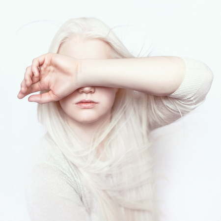 Albino girl with white skin, natural lips and white hair. Photo face on a light background. Portrait of the head. Blonde girlの素材 [FY31088542075]