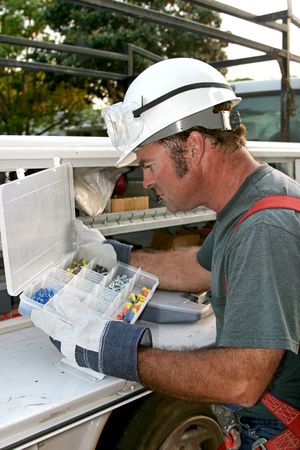 An electrician looking through his tools on his service truck.の写真素材