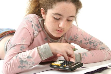 A teenaged girl studying math, using a calculator.の写真素材