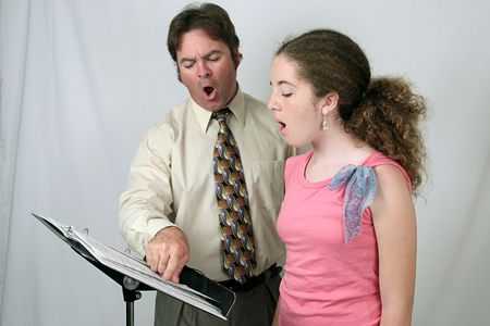 A voice teacher demonstrating to a student how to make the Ohhh sound.の写真素材