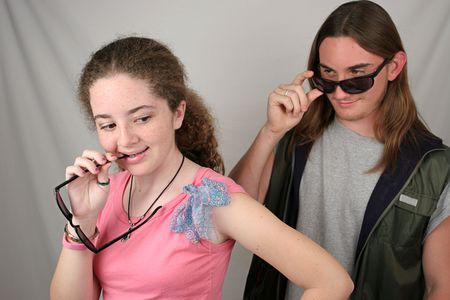 a teenaged boy and girl checking eachother outの写真素材