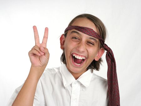 A young boy in his school uniform acting silly like the class clown - isolatedの写真素材