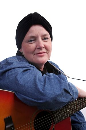 A beautiful woman, bald from chemotherapy, posing with her guitar.の写真素材