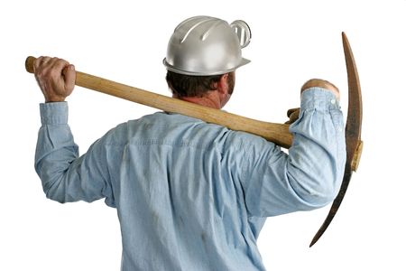 A view from behind a coal miner who's carrying a pickax on his shoulders.の写真素材