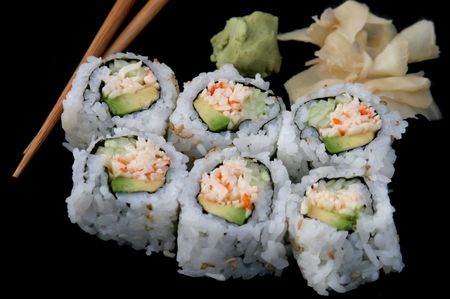 A california roll shushi isolated on black background, with chopsticks and wasabiの写真素材