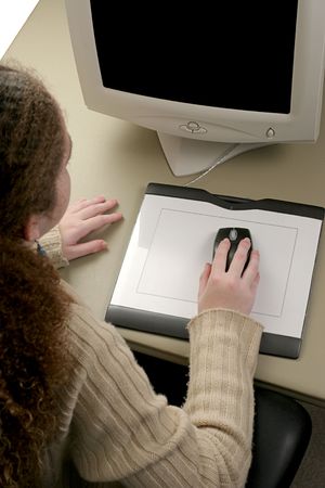 An overhead view of a girl using a graphic tablet mouse.の写真素材