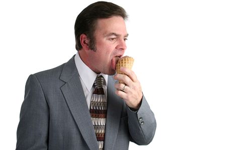 A businessman eating an ice cream cone.の写真素材