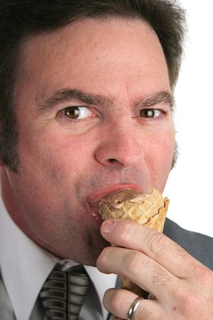 A closeup of a businessman eating ice cream.の写真素材