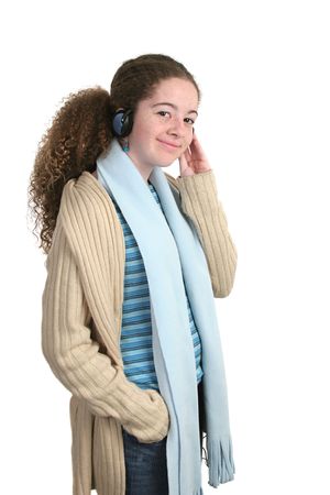 A teen girl enjoying listening to music through headphones.  Isolated.の写真素材