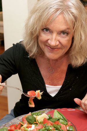 A beautiful woman staying fit and youthful by eating right.の写真素材
